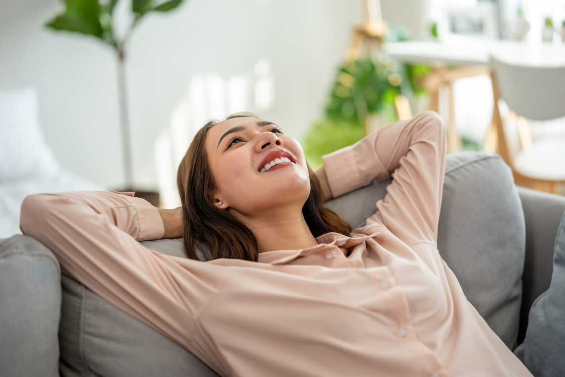 A lady is relaxing on a sofa A lady is relaxing on a sofa