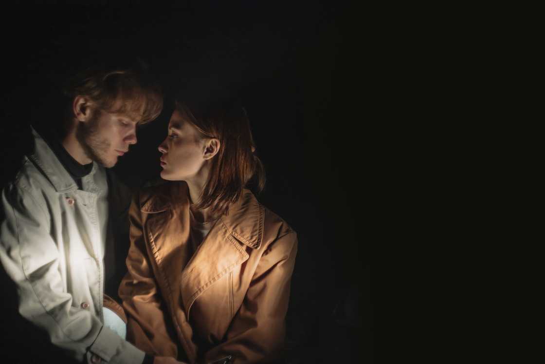 A worried couple in a dark room