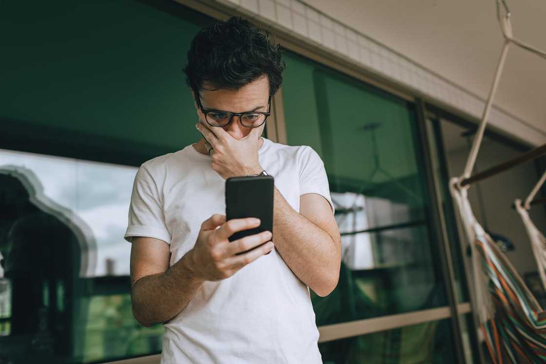 A person reacts to a message on their phone.