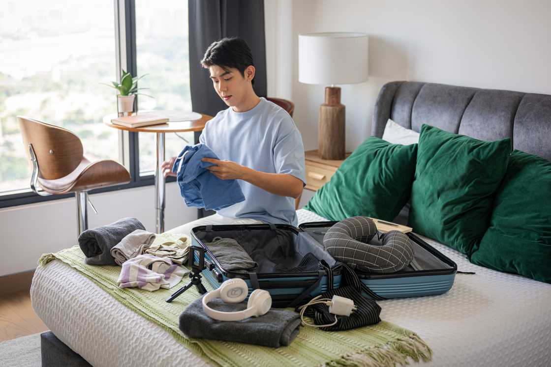 A man folds clothes