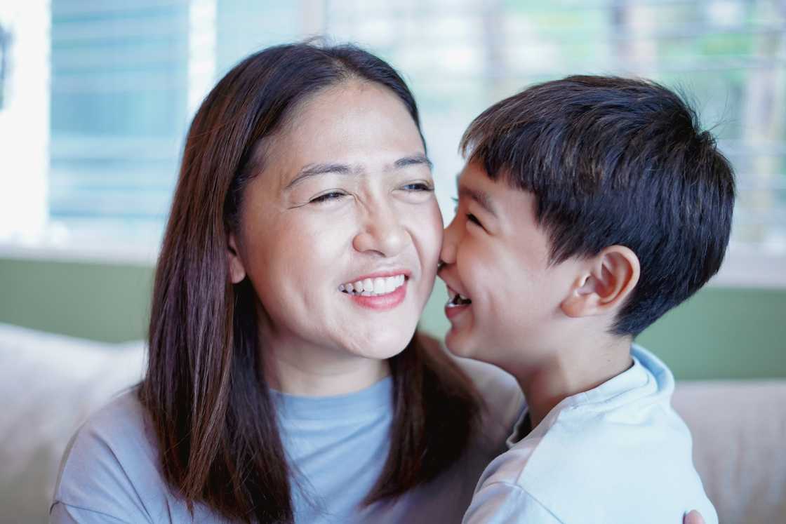 A happy mother and son sitting on the sofa. A happy mother and son sitting on the sofa.