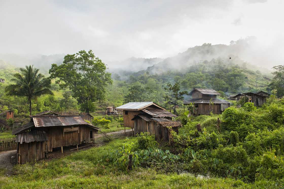 Filipino village with wooden houses and metal roofs.
