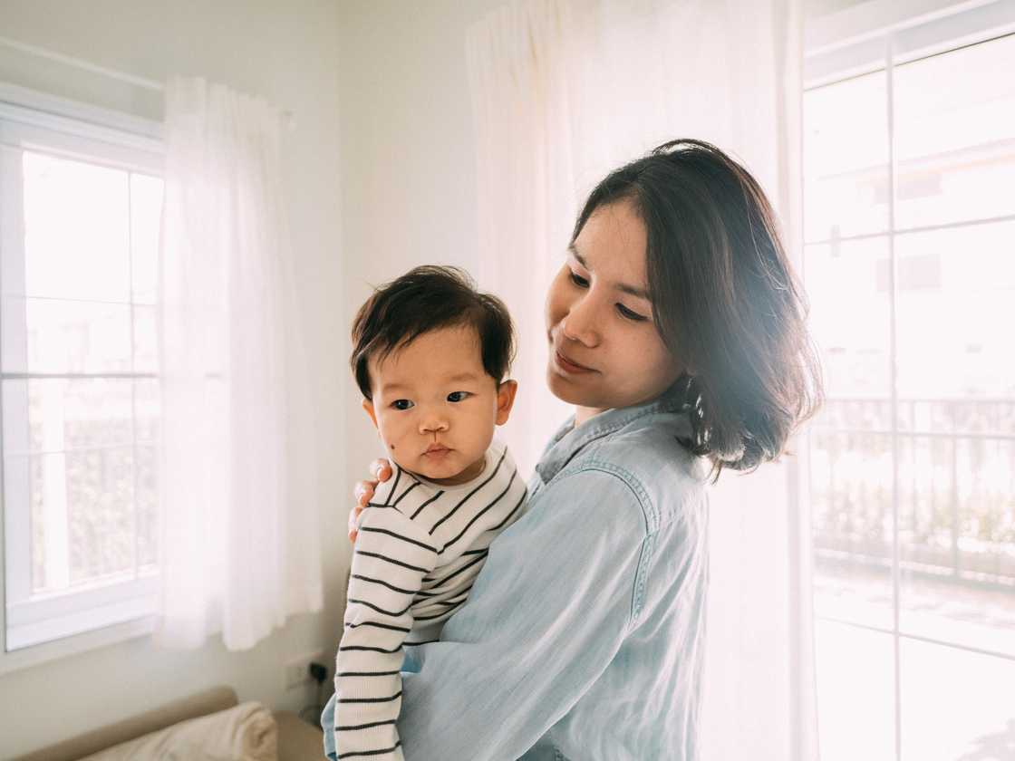 A maother is carrying her son