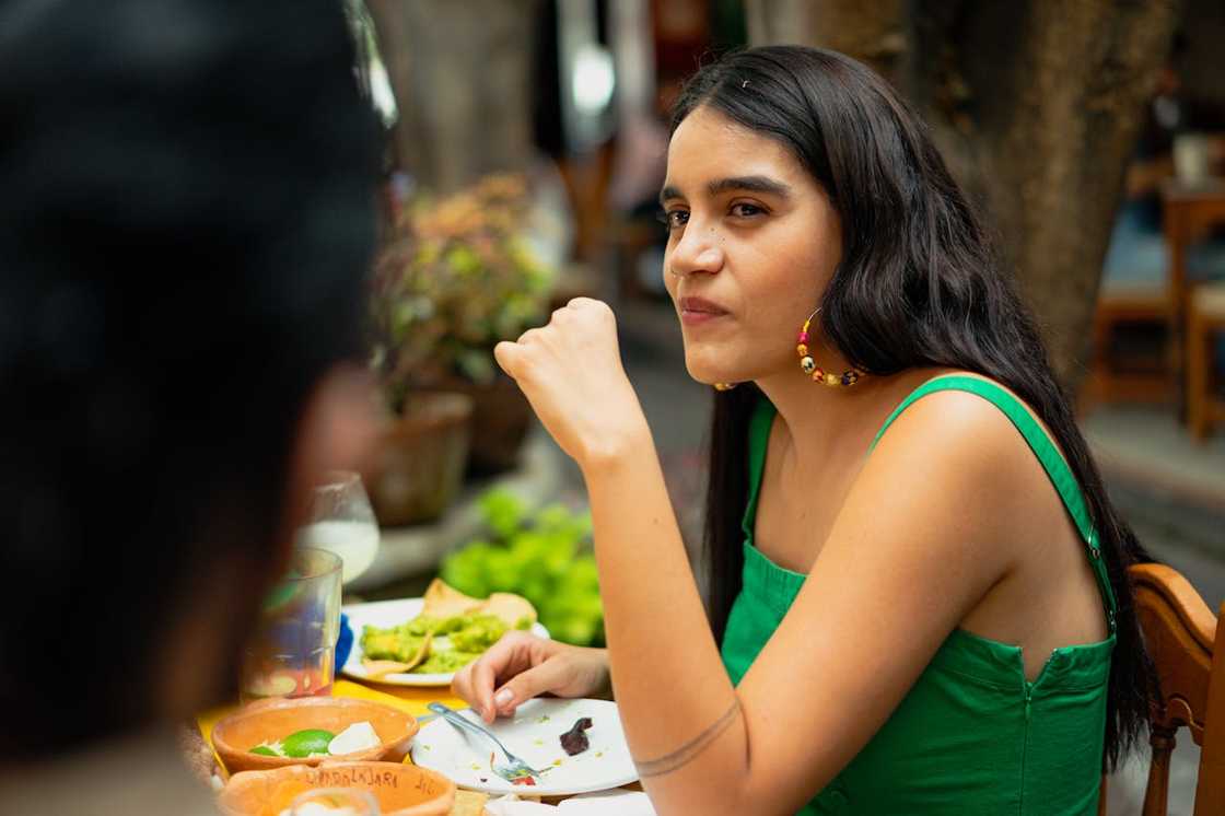 A woman listens intently while sitting across from a man at a table. A woman listens intently while sitting across from a man at a table.