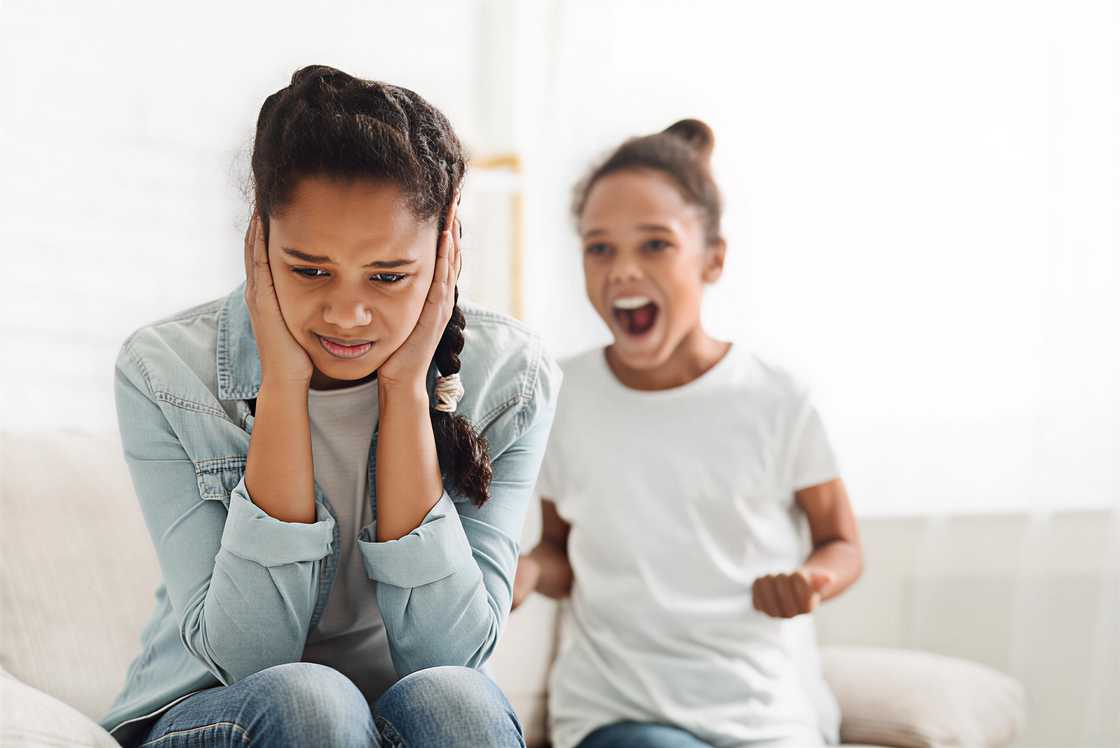 A hysterical black girl yelling at her older sister