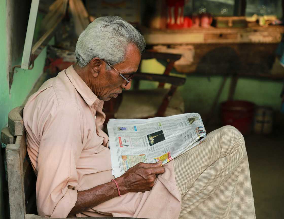 A senior man reading a newspaper