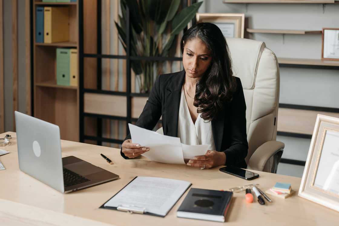 A woman checking affidavits in an office