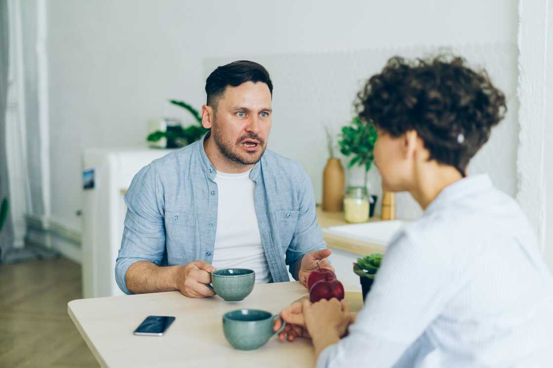 A couple talking as they have breakfast A couple talking as they have breakfast