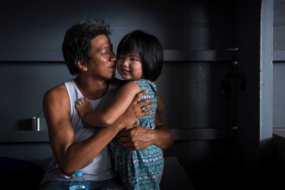 A man is all smiles with his daughter