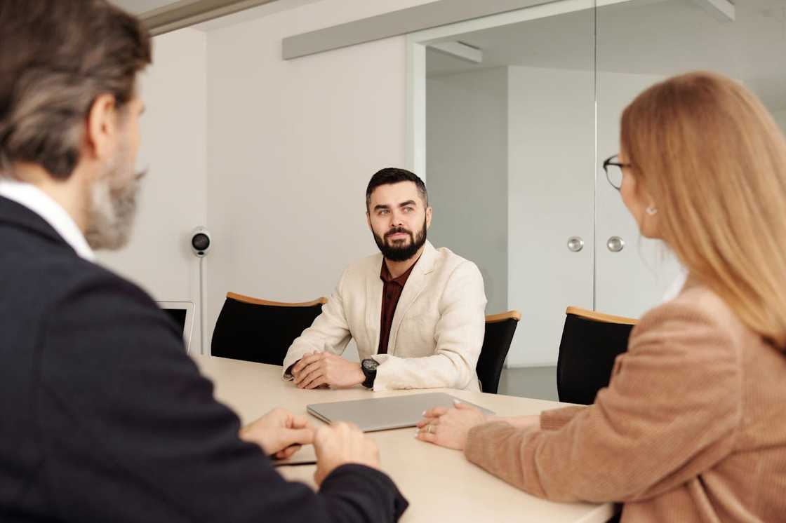 A man sits during a job interview.