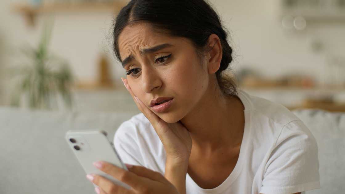 A lady reads shocking news on phone A lady reads shocking news on phone