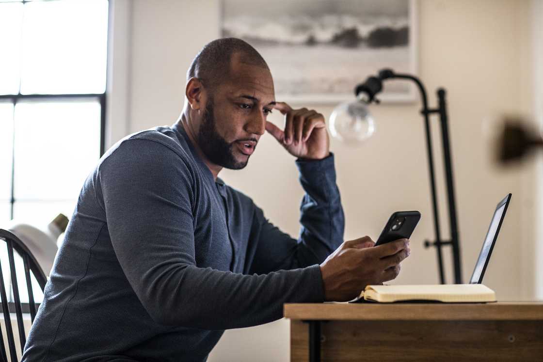 A man poses in a residential office.