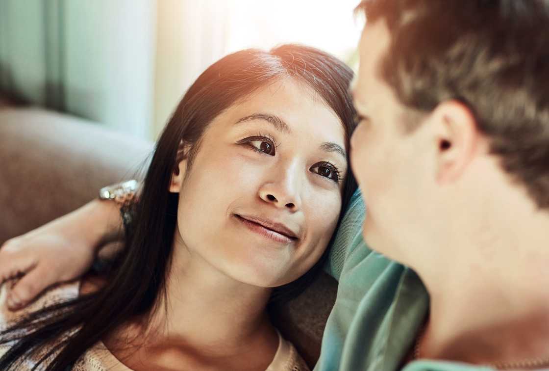A young couple having a conversation while relaxing at home