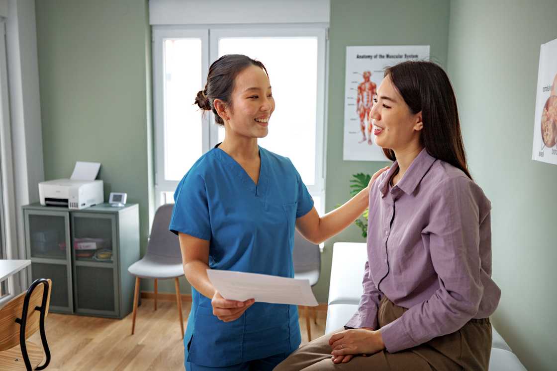 A female nurse is talking with a patient A female nurse is talking with a patient