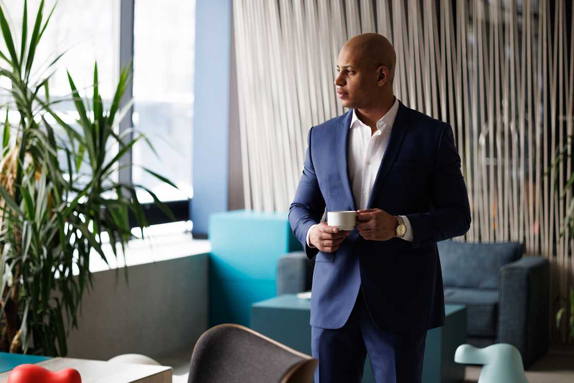 Elegant businessman holding a cup of coffee. Elegant businessman holding a cup of coffee.