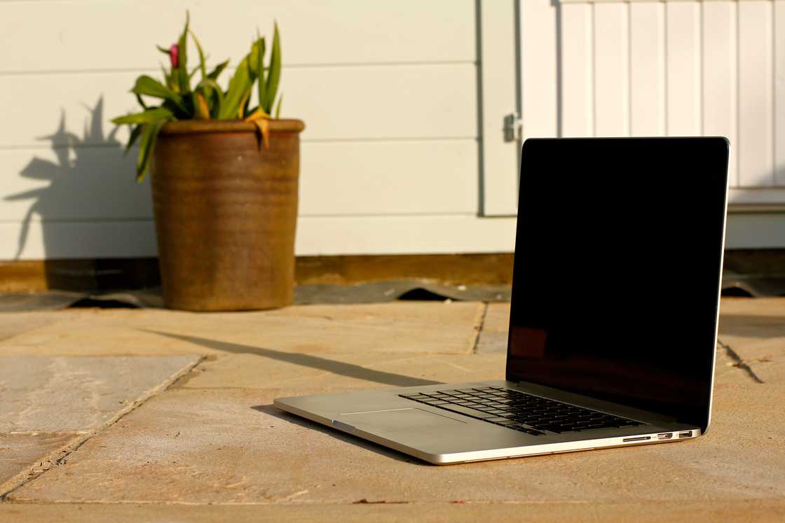 A laptop place outside on patio