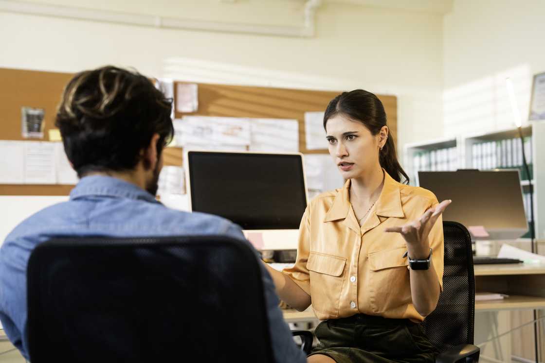 An upset employee talking with her boss
