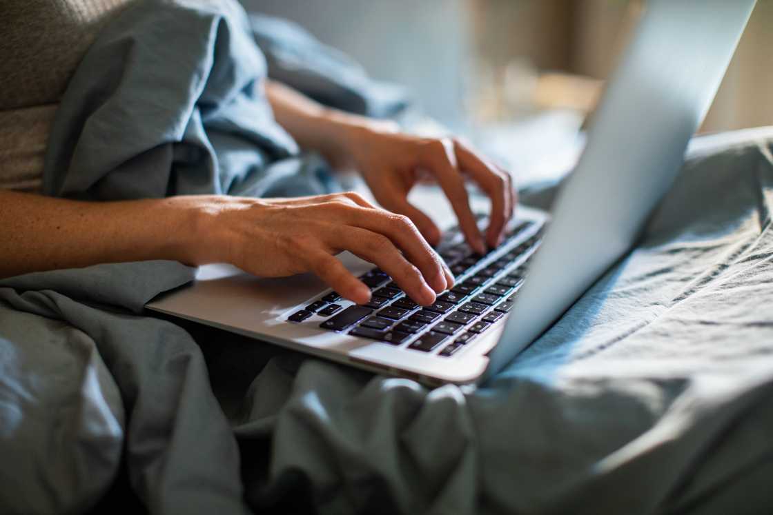 A lady scrolls on her laptop A lady scrolls on her laptop