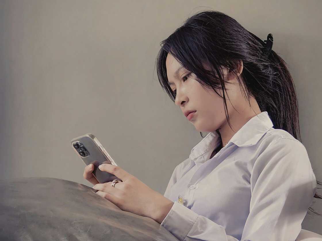 A serious woman checking her phone A serious woman checking her phone