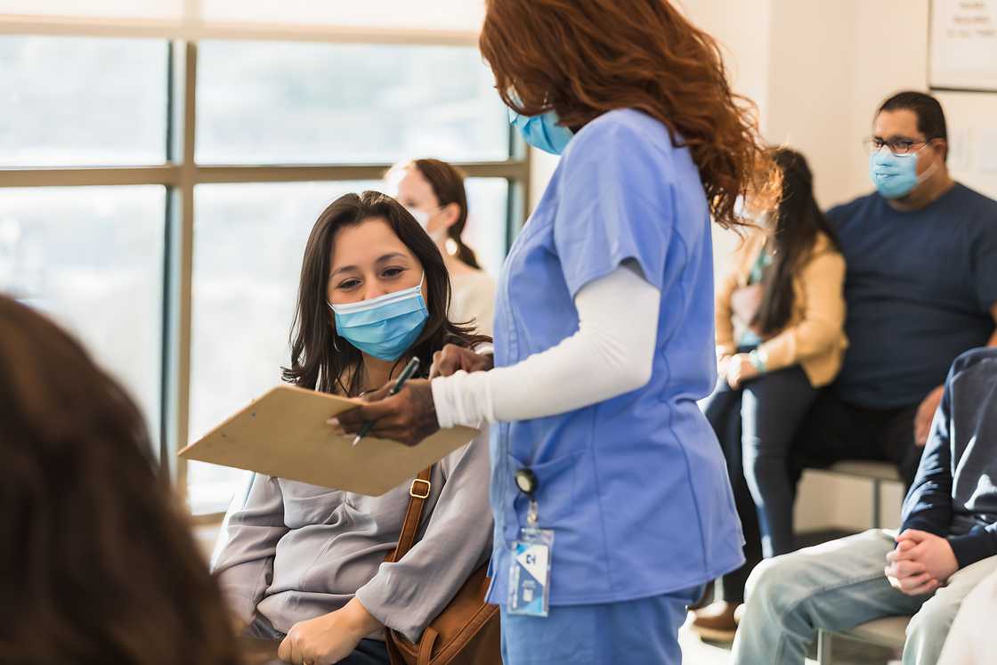 A healthcare worker is talking with a patient