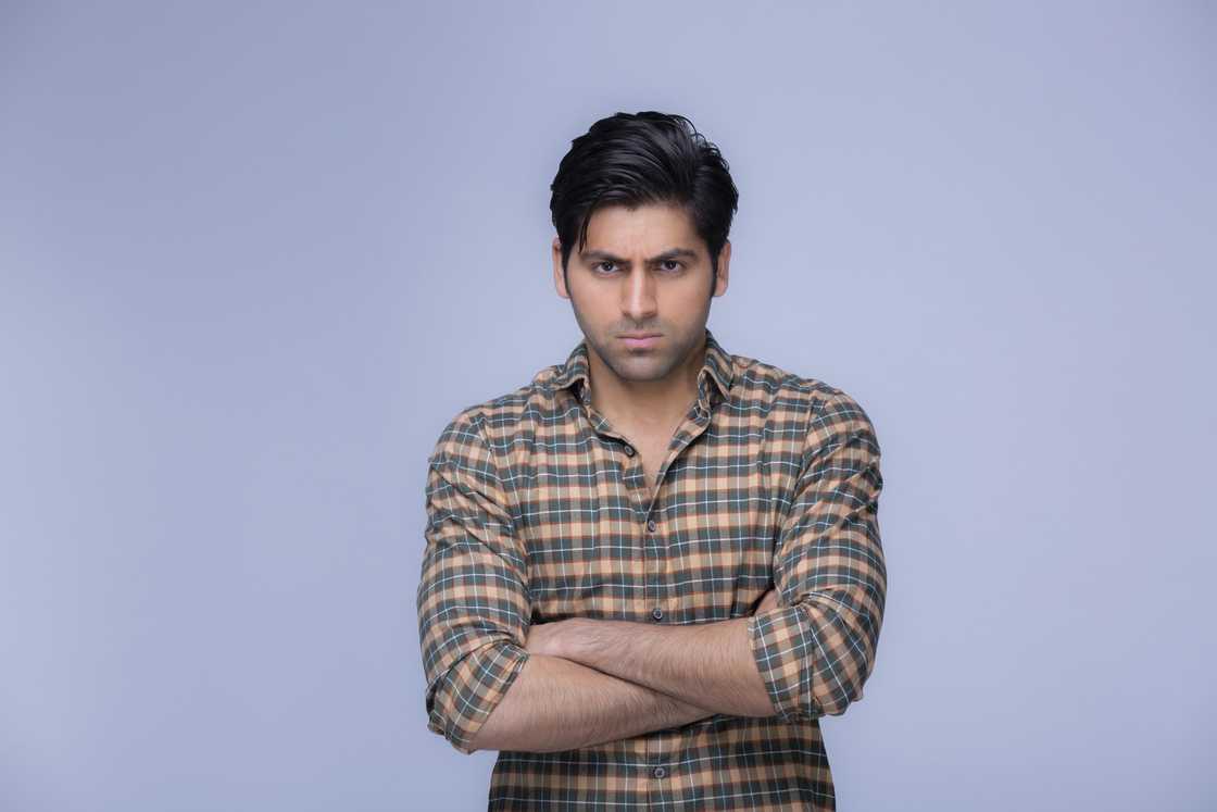 An angry man crossing his arms