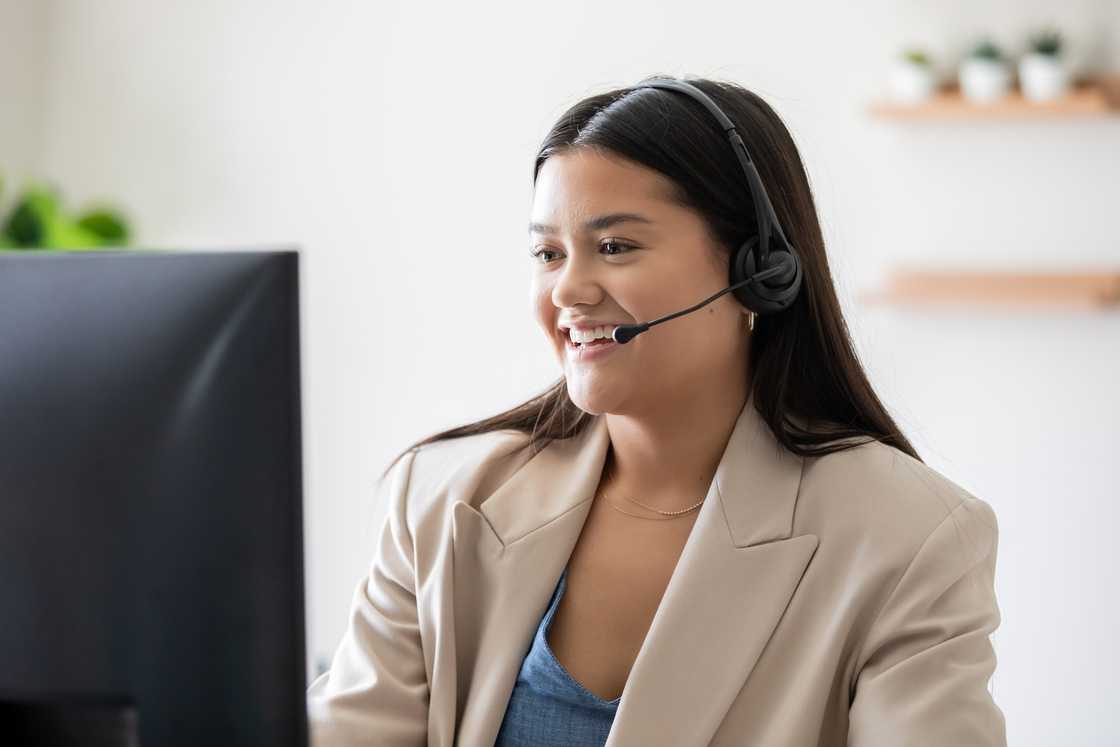 A call centre agent speaks gently during a live customer call.