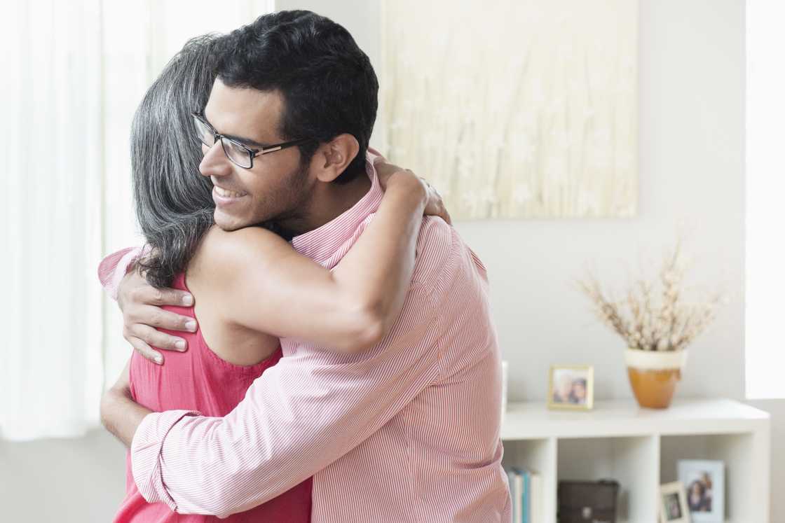 A mother and son hugging
