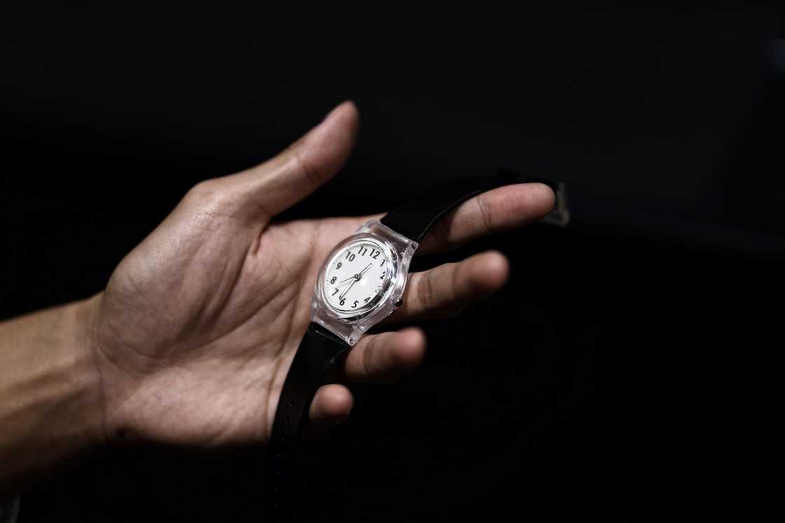 A man holds a watch