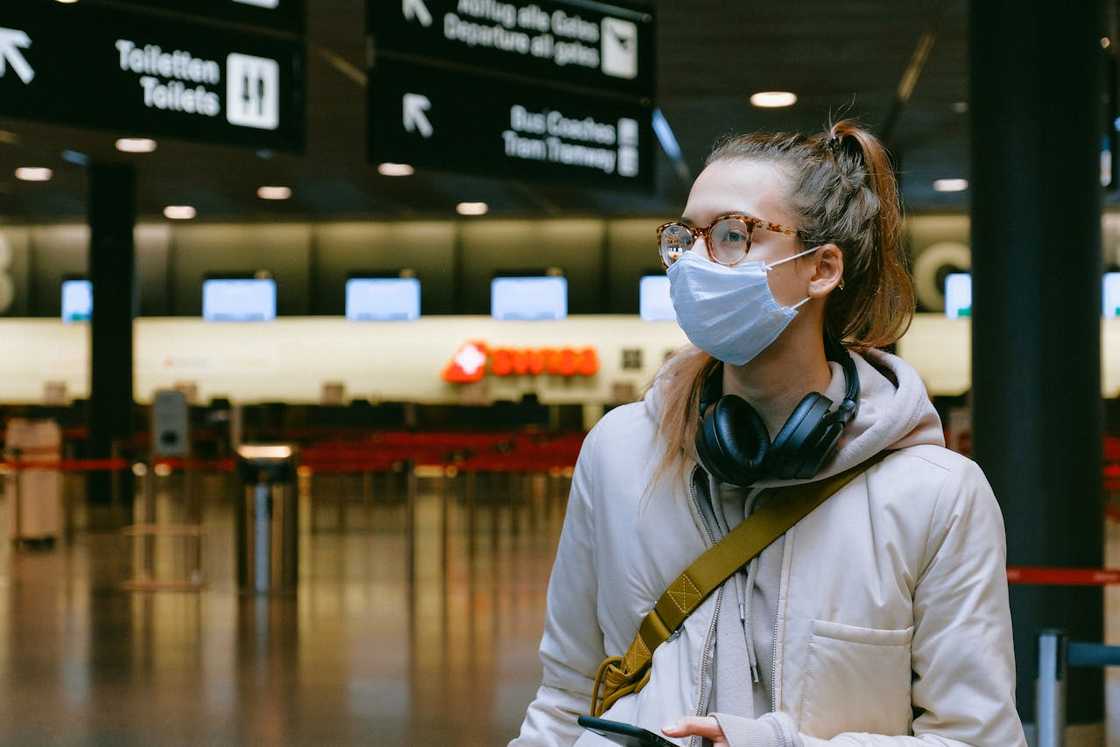 A woman rushing with luggage through airport security. A woman rushing with luggage through airport security.