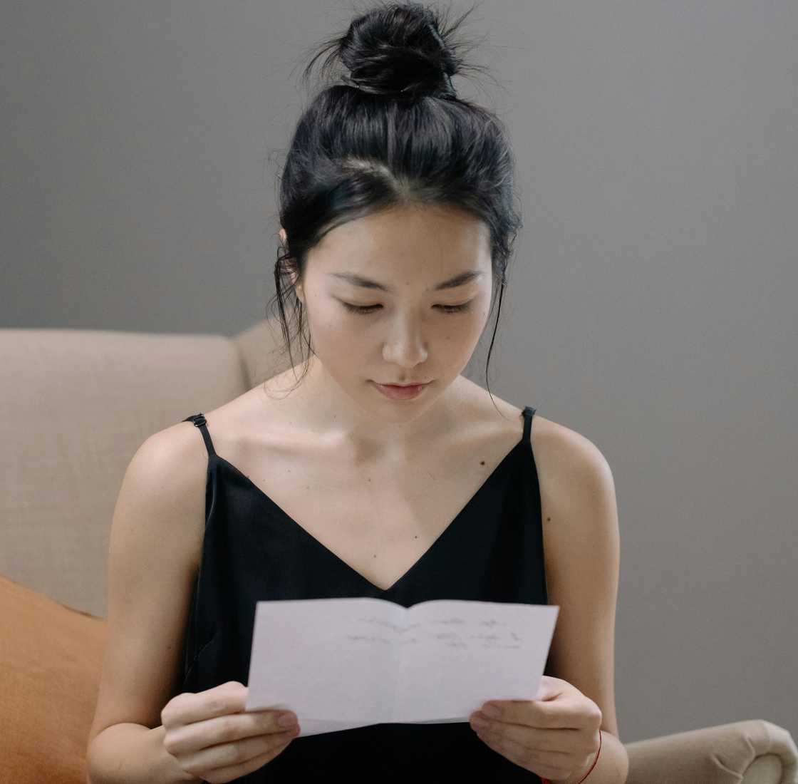 A woman reading a letter