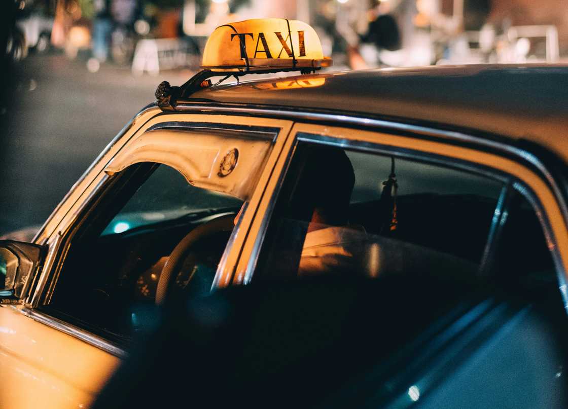 A taxi driver at night