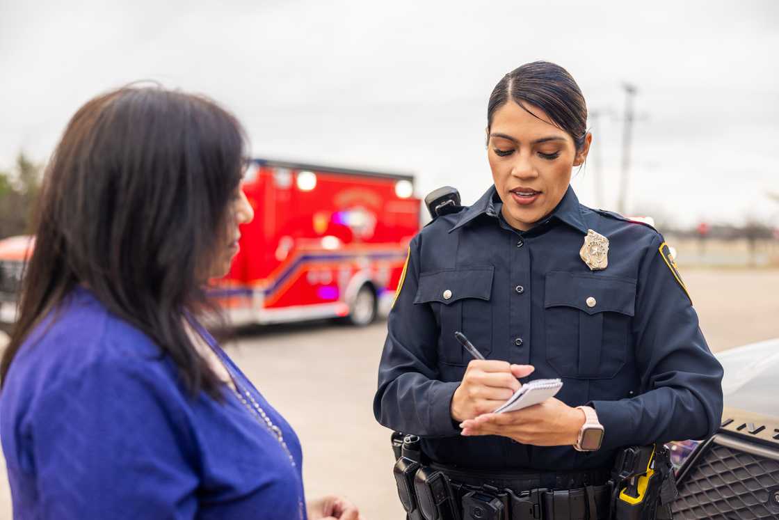 A police woman talking with a fellow lady