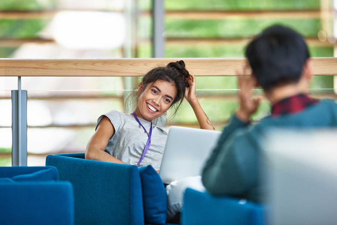 two coworkers having a discussion in a modern office