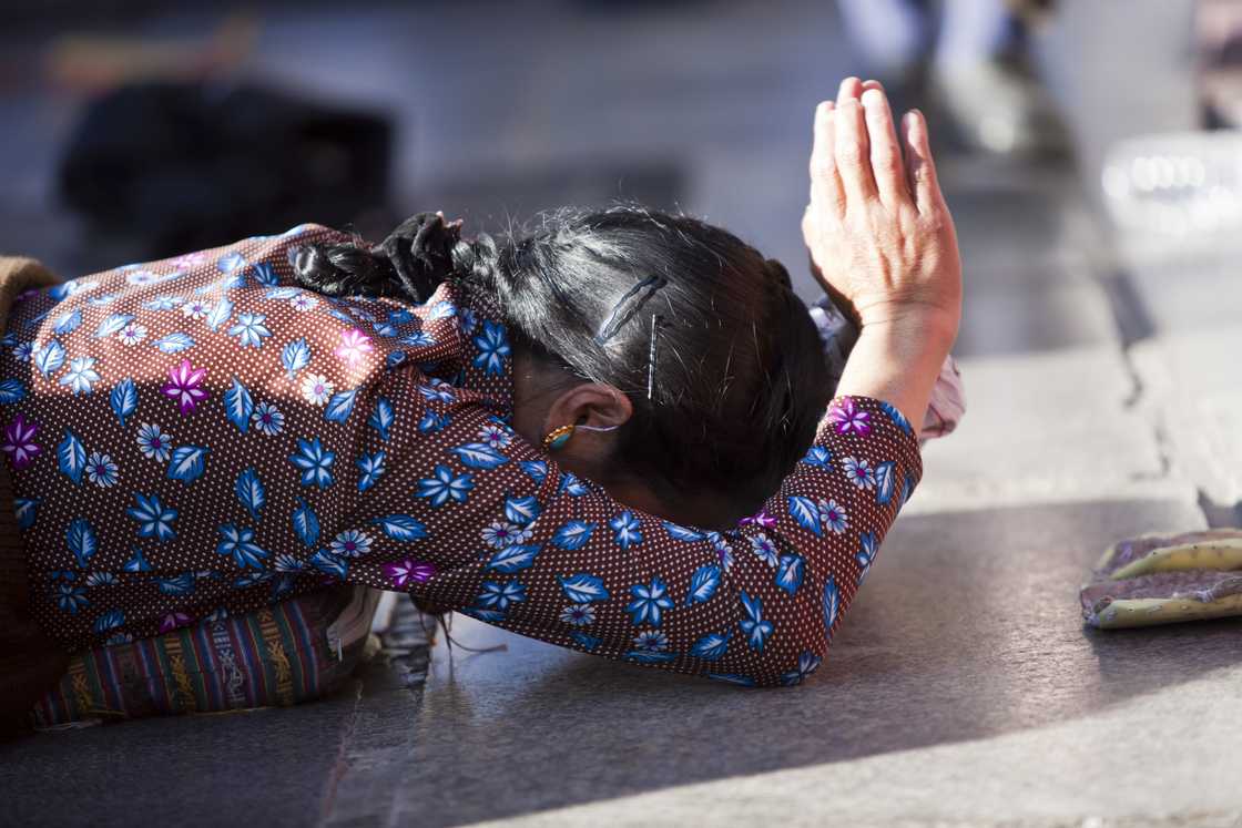 A lady is asking for forgiveness while kneeling A lady is asking for forgiveness while kneeling