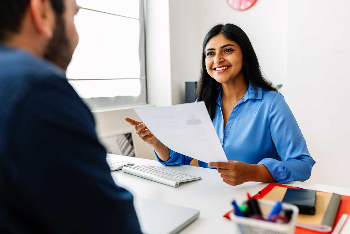 A lady is talking with her boss in an office A lady is talking with her boss in an office