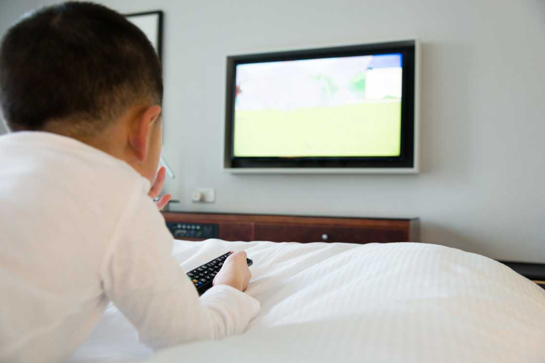 A young boy is watching tv