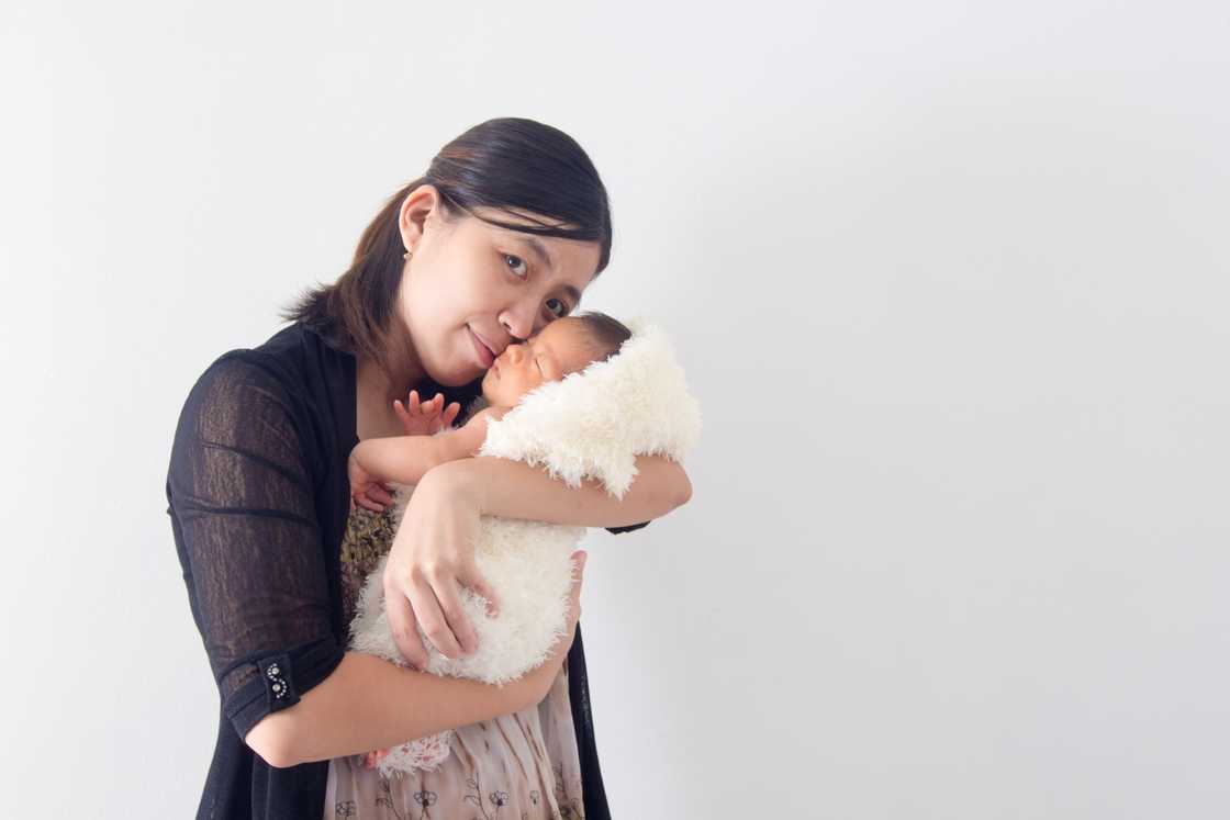 Asian woman carrying baby Asian woman carrying baby