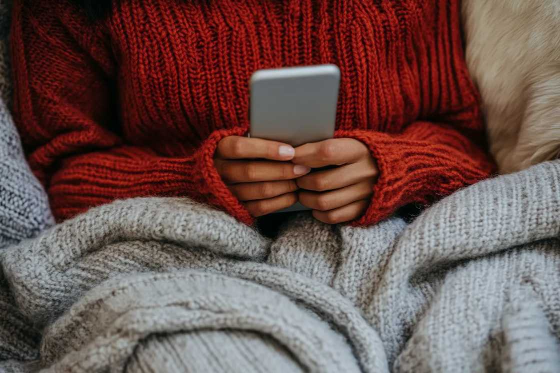 A woman holding her cell phone A woman holding her cell phone