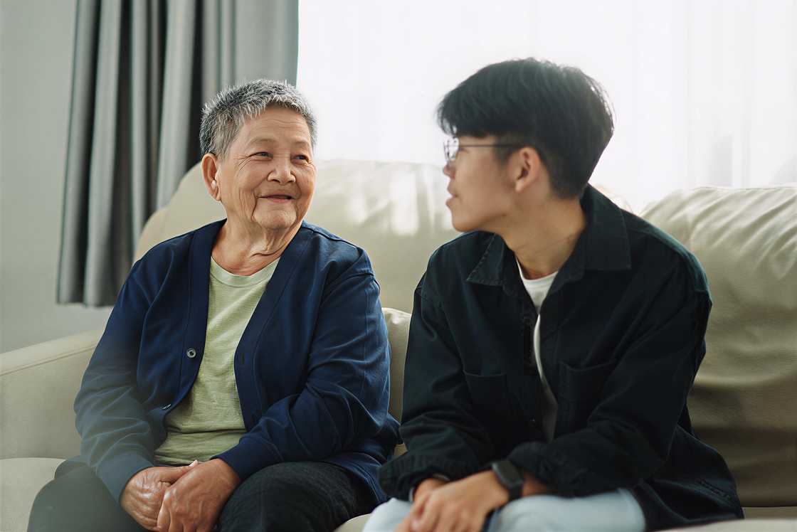 Asian senior woman relaxing, talking with her grandson Asian senior woman relaxing, talking with her grandson