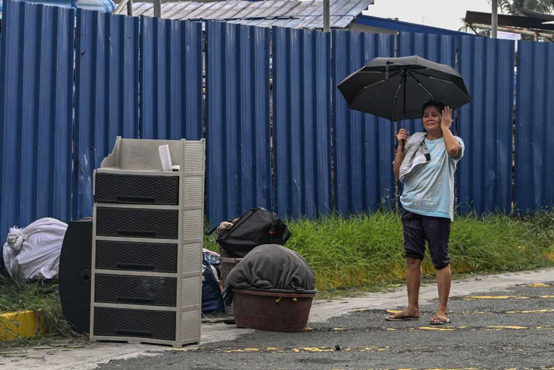 Woman outside with her belongings.