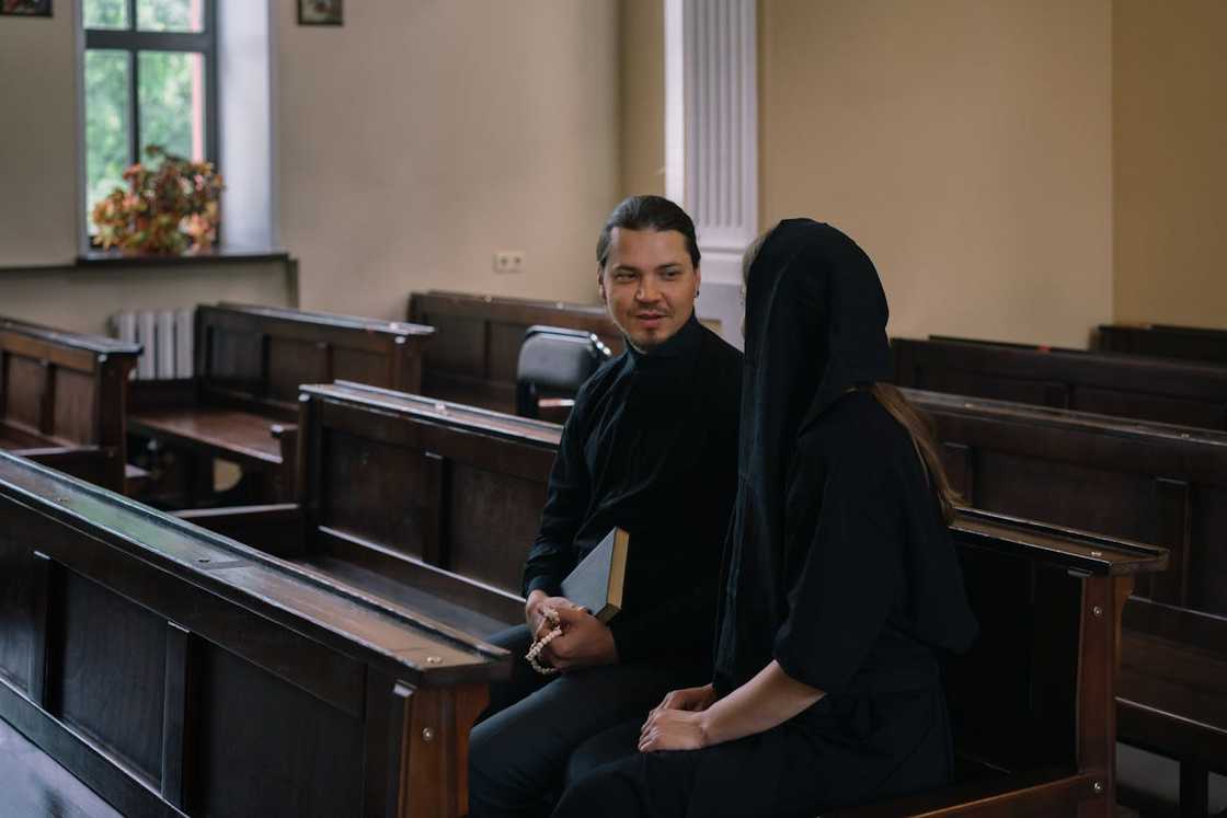 A pastor talks to a female congregant inside the church.