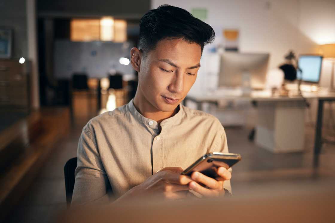 A man is using his phone A man is using his phone