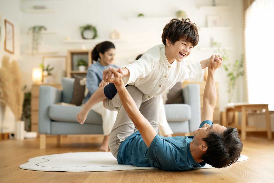 A father plays with his young son