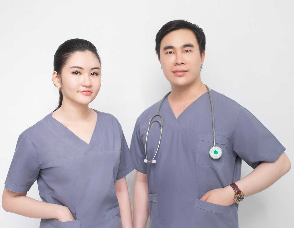 Nurses whisper near a worried patient. Nurses whisper near a worried patient.