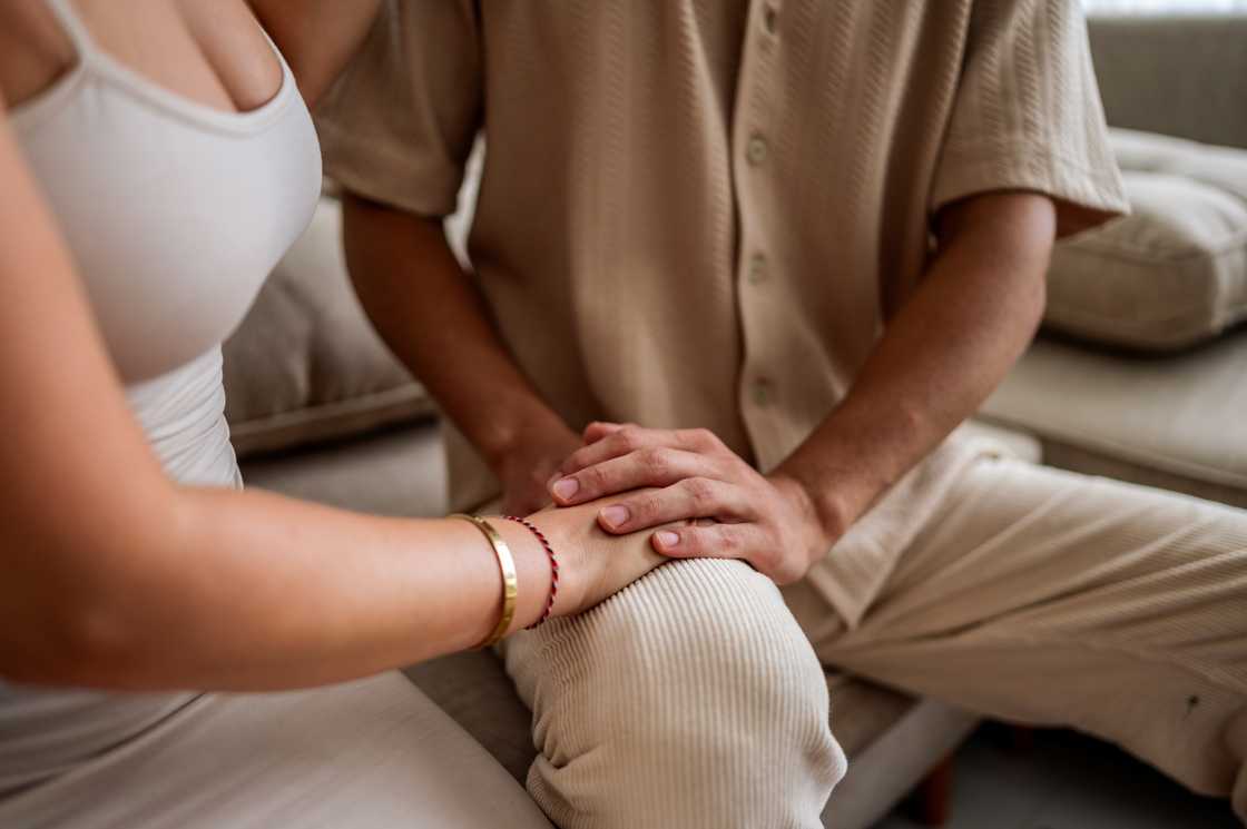 A man consoles his wife