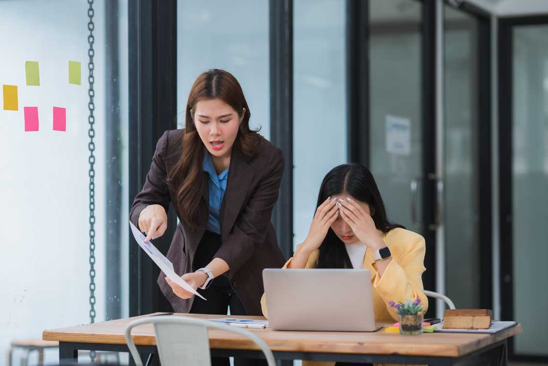 A woman is accusing her colleague in the office A woman is accusing her colleague in the office