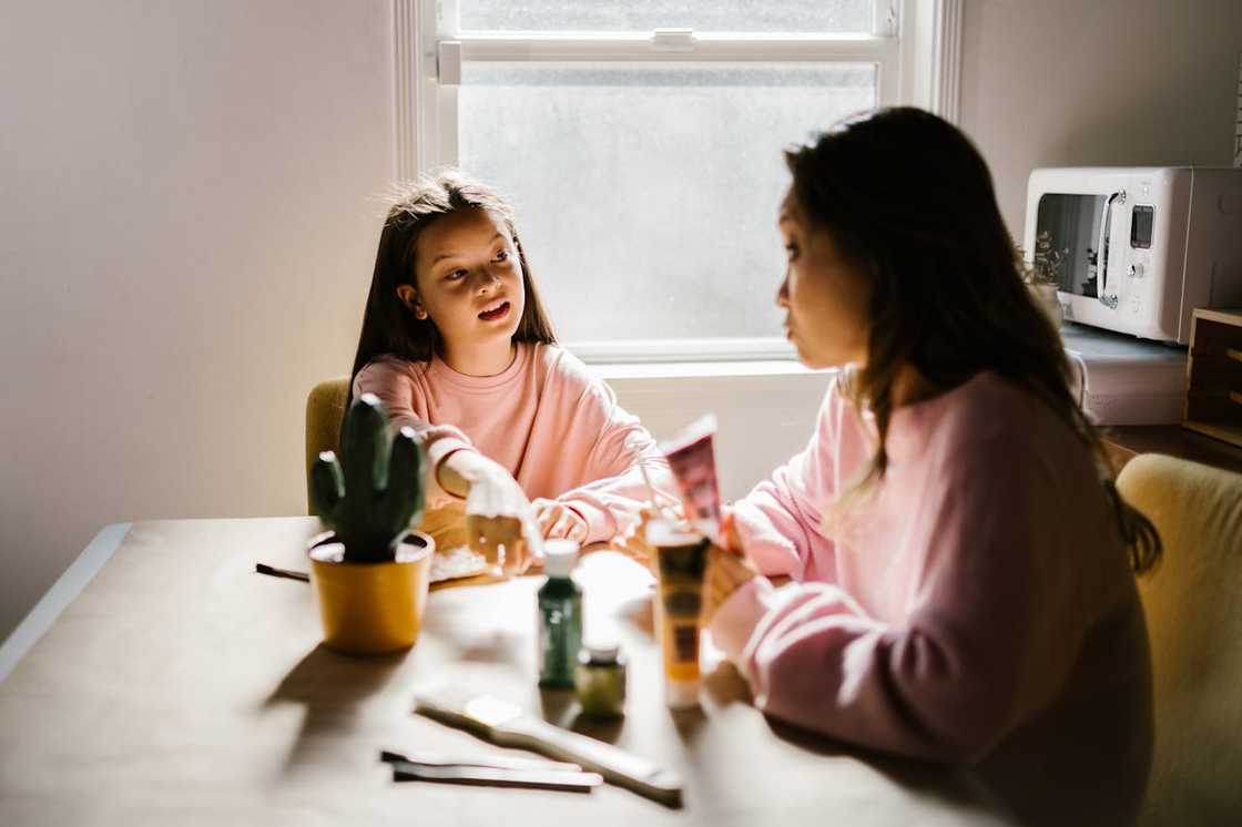 A mother and daughter having a conversation at home.