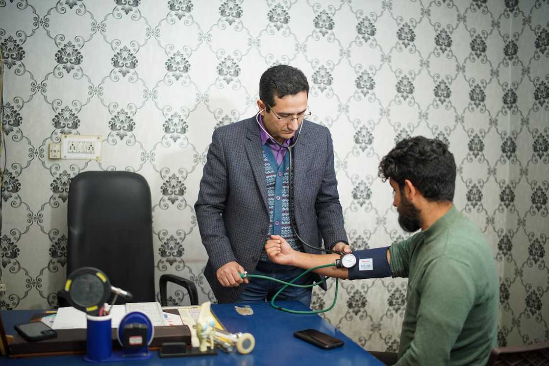 A doctor checks a man’s blood pressure during a clinic visit. A doctor checks a man’s blood pressure during a clinic visit.