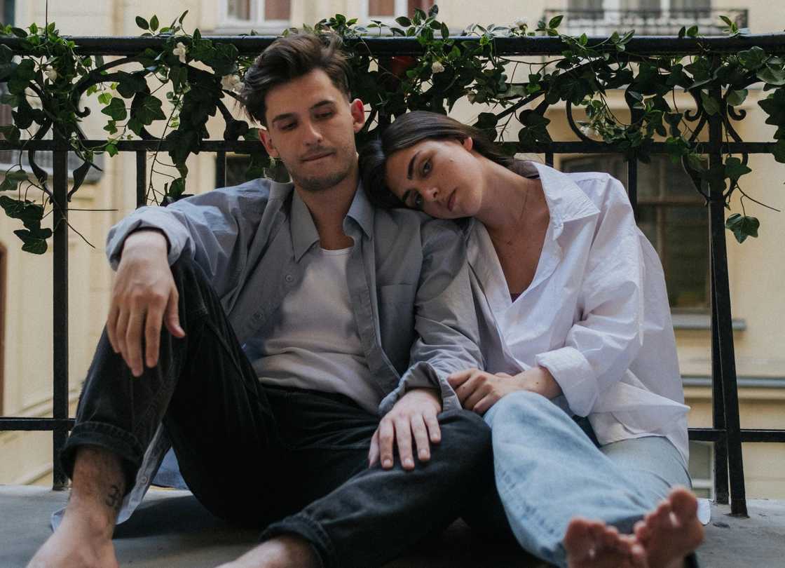 A couple sitting on a balcony