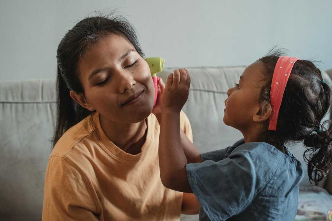 A woman spending time with a child at home